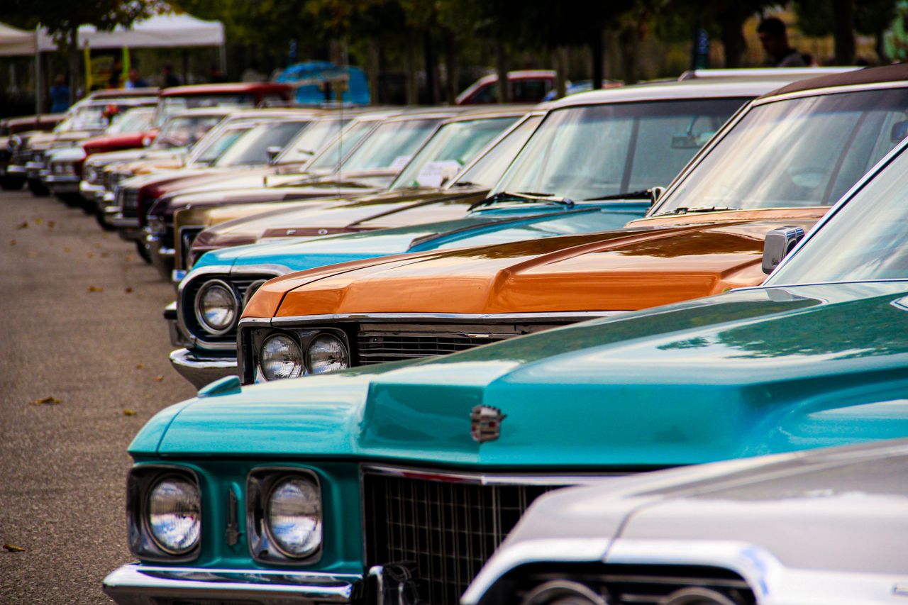 Home A row of classic vintage cars displayed outdoors. Perfect for car enthusiasts and retro themes.