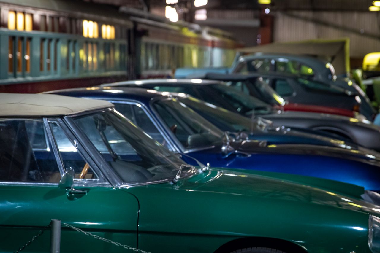 Home Row of classic vintage cars parked indoors, showcasing elegance and history.